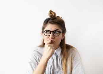 Woman with glasses thinking