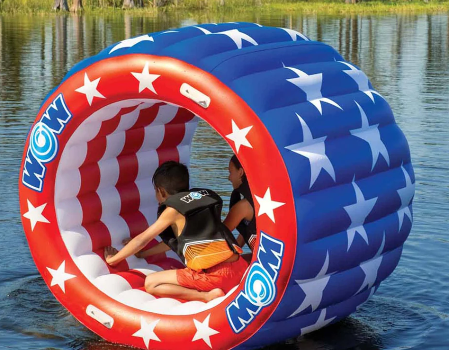 Two kids on the lake using the patriotic water wheel