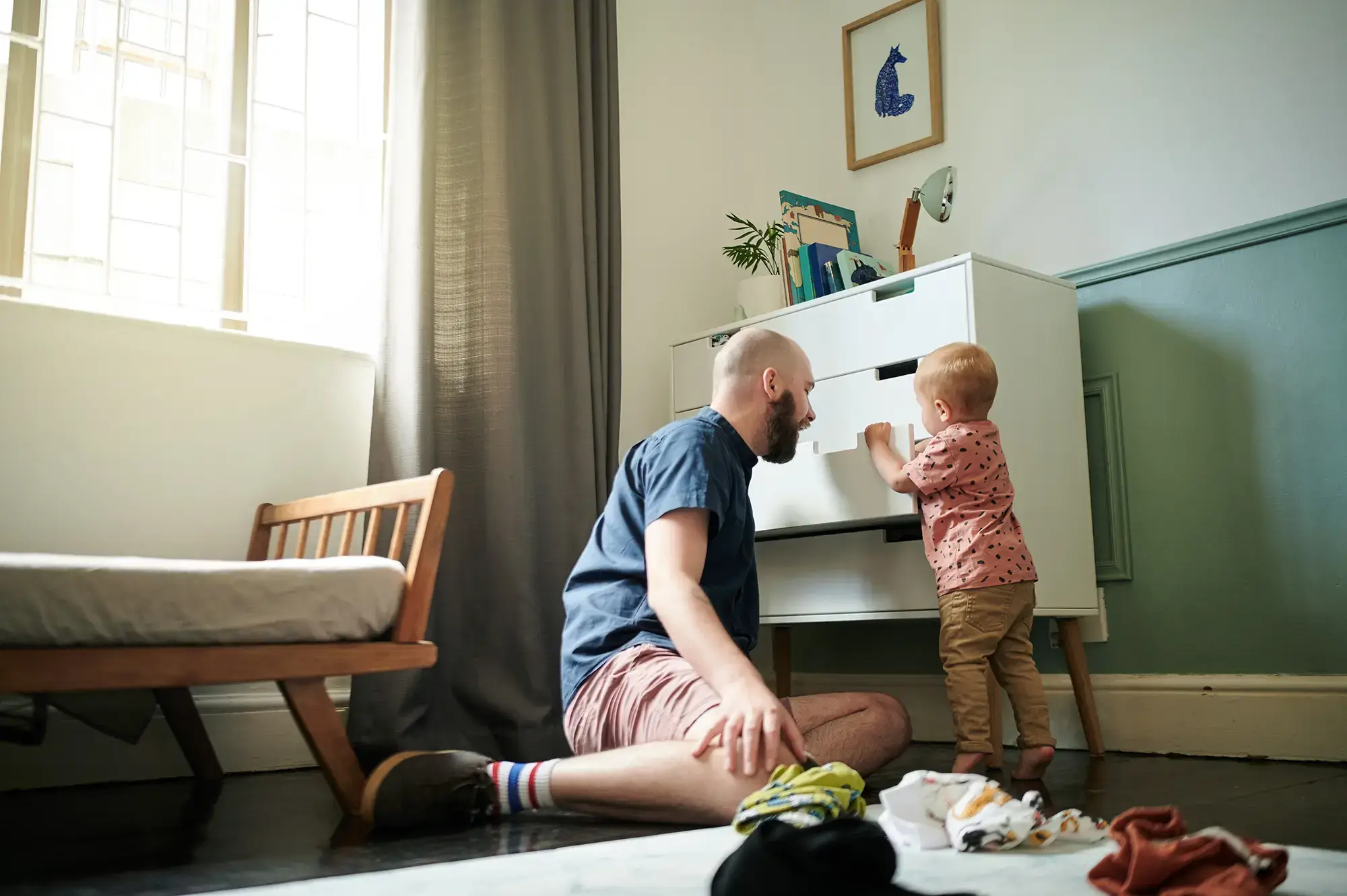 Getting ready, children and a man helping his son to pick an outfit from the cupboard in a bedroom. Kids, clothes and dressing with a young father teaching his toddler child about chores or packing