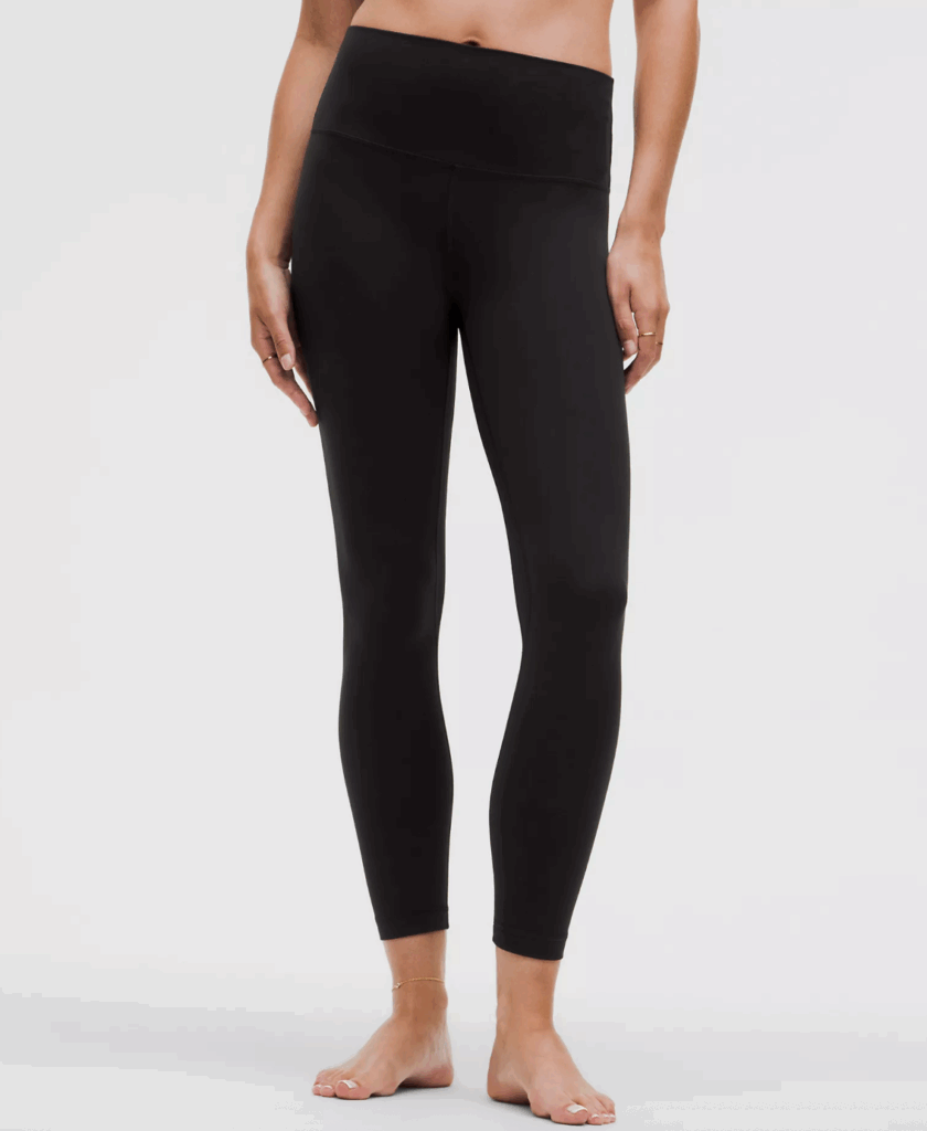 Model wearing high-waisted black leggings, showcasing a sleek design and comfortable fit for activewear.