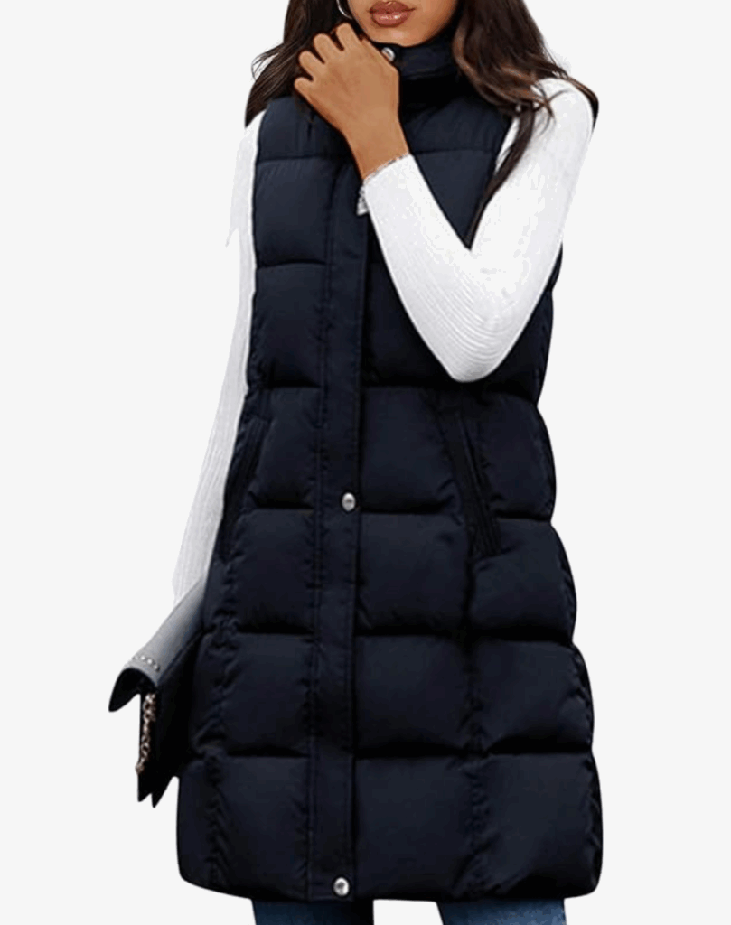 Stylish woman in a black puffer vest over a white long-sleeve top, showcasing a modern winter outfit.