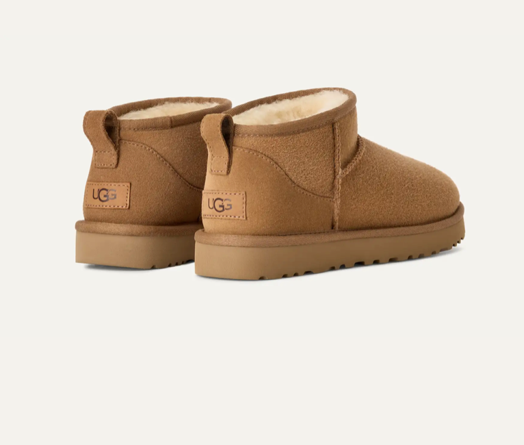 Brown UGG boots featuring soft fur lining and a sturdy sole, perfect for comfort and style.