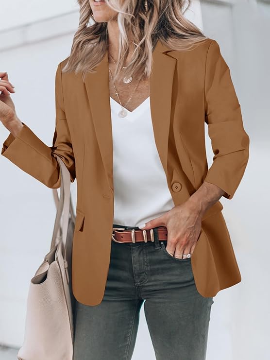 Stylish woman in a brown blazer and white shirt, accessorized for a chic, modern look.