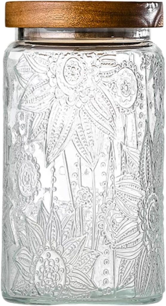 Decorative glass jar with embossed floral design and wooden lid, perfect for storage or as a decorative piece.