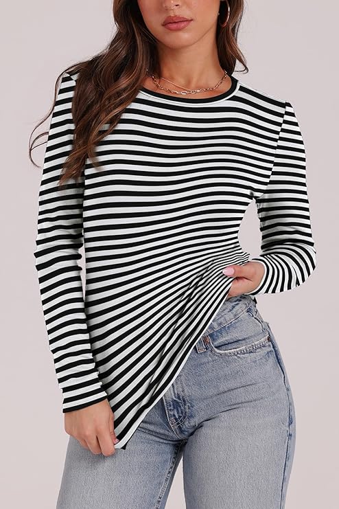 Model wearing a black and white striped long sleeve top paired with light blue jeans.