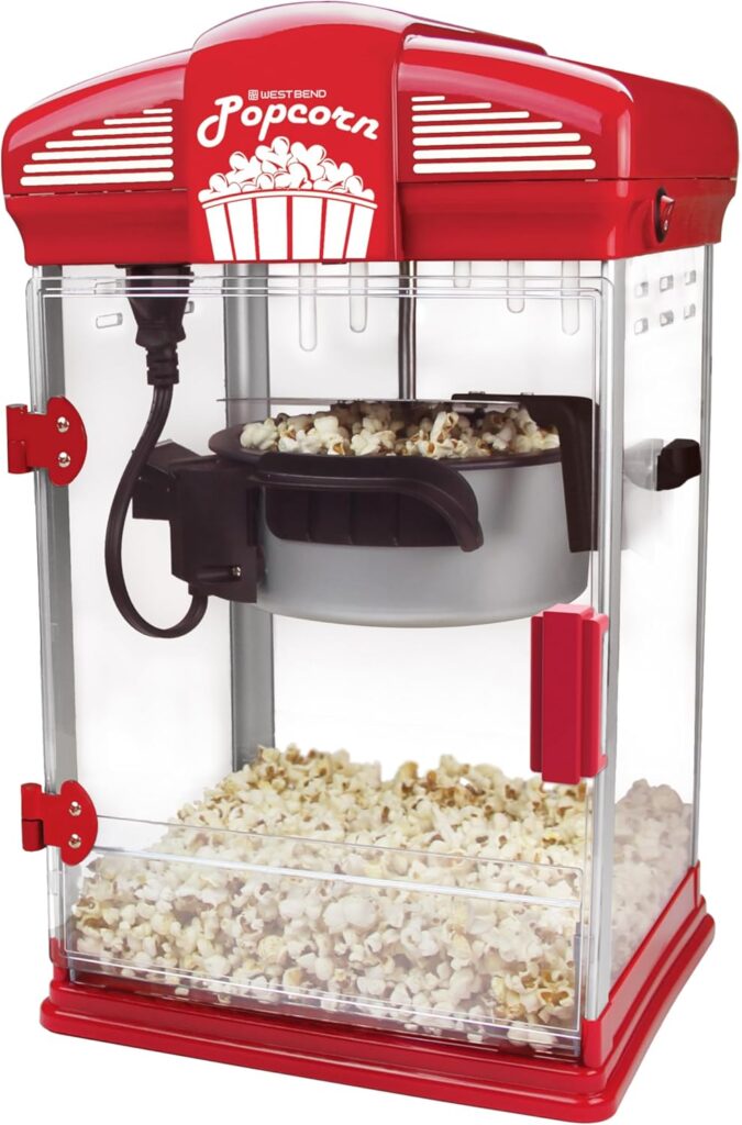 Red popcorn machine with a glass front, filled with fresh popcorn, designed for home or theatrical use.