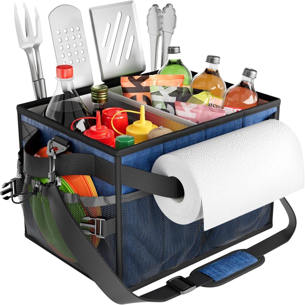 A picnic caddy filled with vegetables, grill accessories, and a paper towel roll