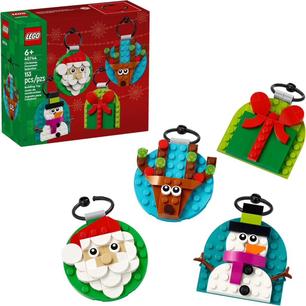 A LEGO box next to four pre-made Santa, reindeer, snowman, and present ornaments.
