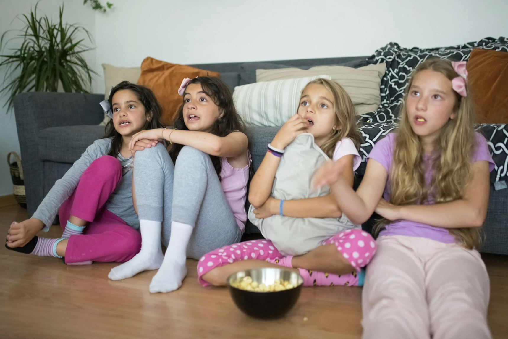 girls watching tv eating popcorn