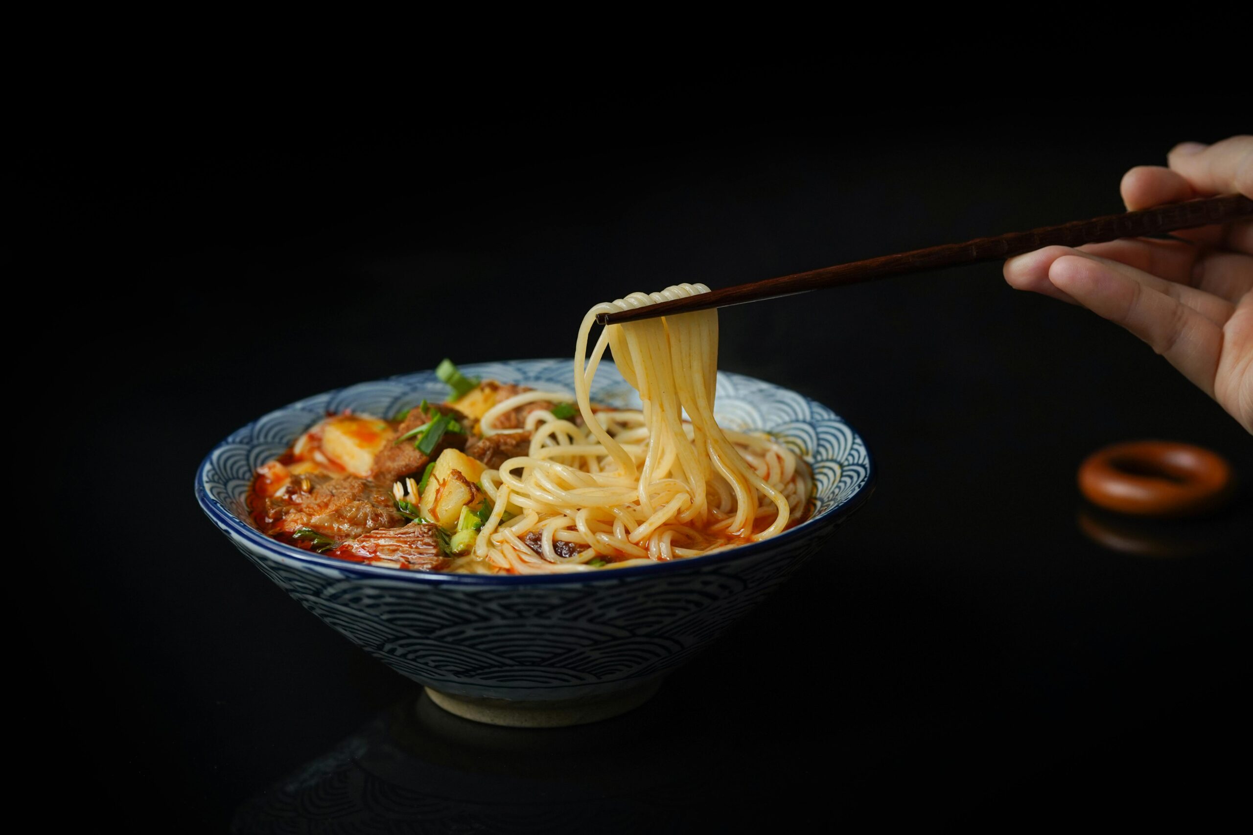 winter recipes, beef & noodles in a bowl with chopsticks.