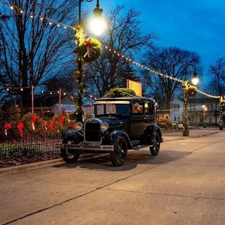 A classic Model T cruising through the beautifully decorated streets, adding a little old-fashioned charm to the Christmas season.