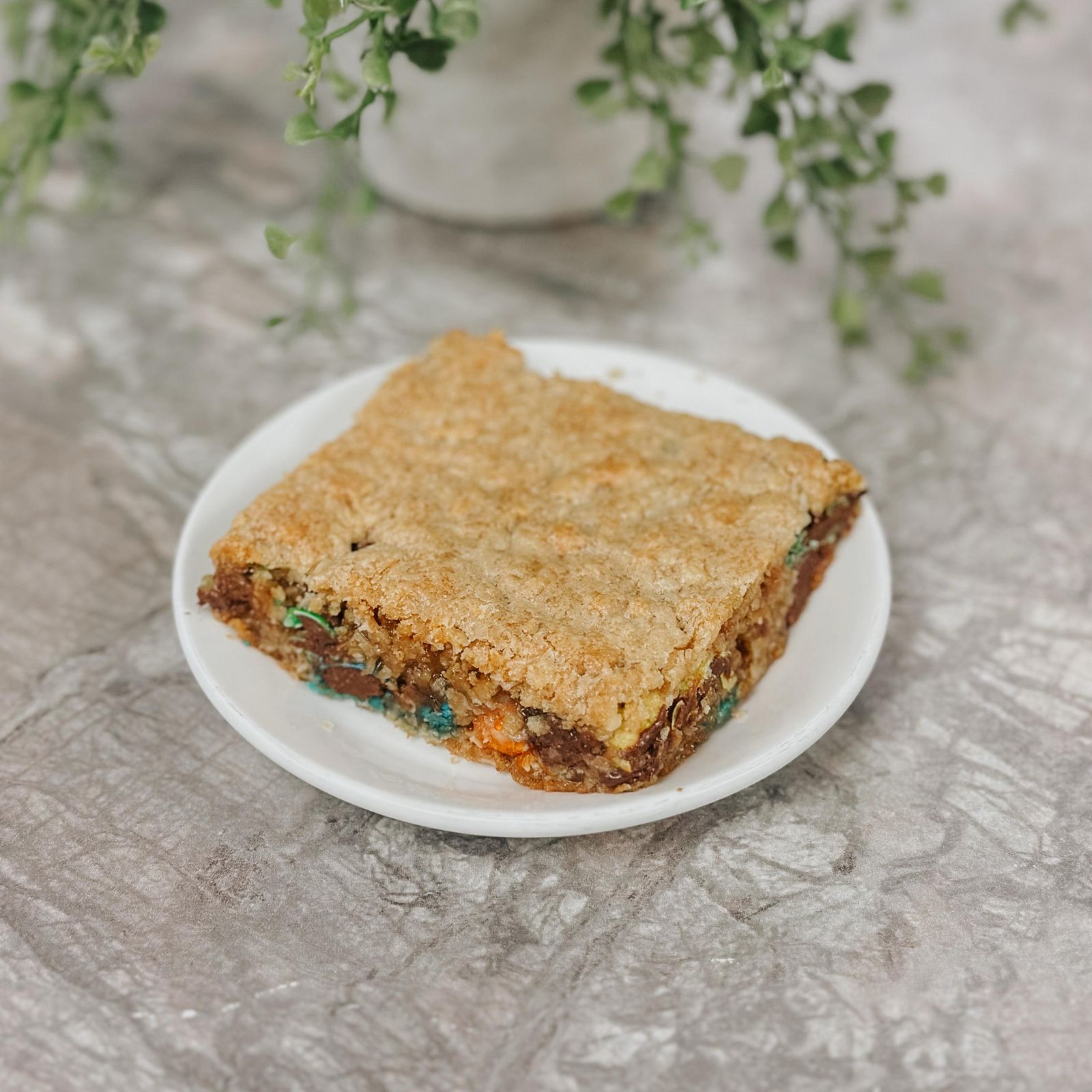 A cookie bar with chocolate and sprinkles on a plate