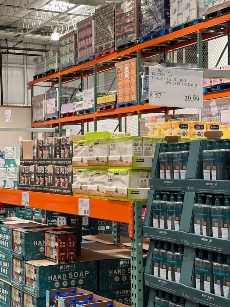 Costco Black Friday shopping in a warehouse club aisle with bulk shelves