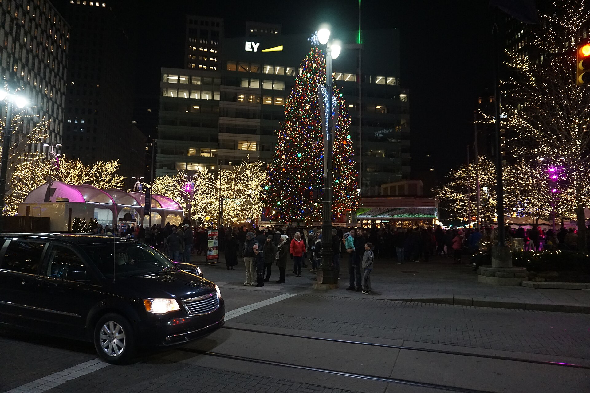 Things to do in Detroit for the holidays: the lit Christmas tree at Campus Martius Park at night with a crowd gathered around it