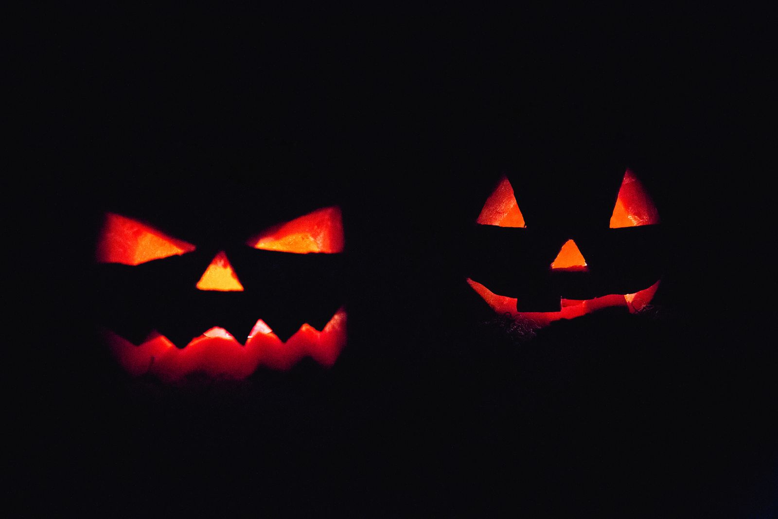 Two glowing jack-o-lanterns in the dark, Halloween night