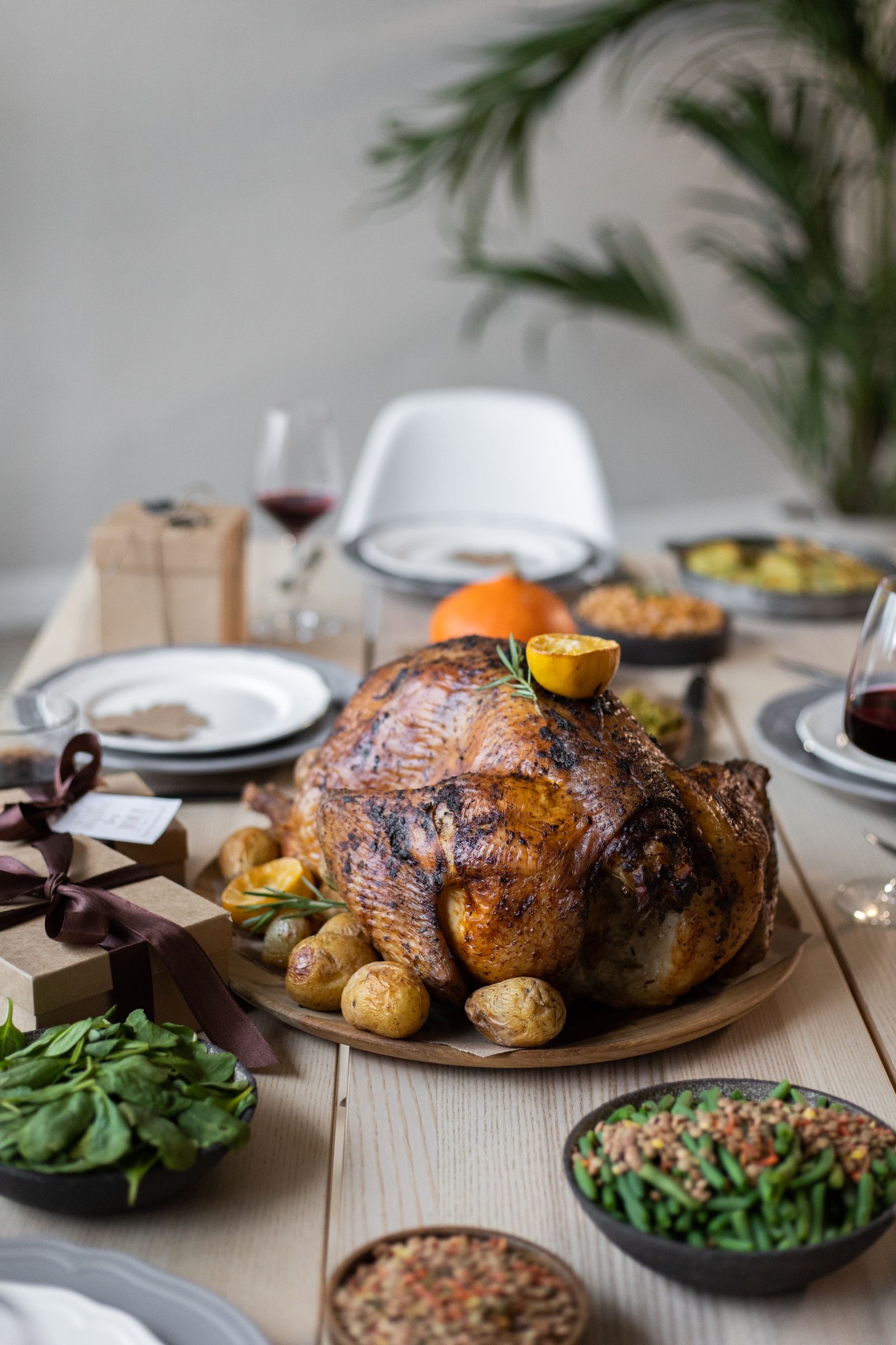 How to host Thanksgiving — a laid table with the roast turkey and sides out