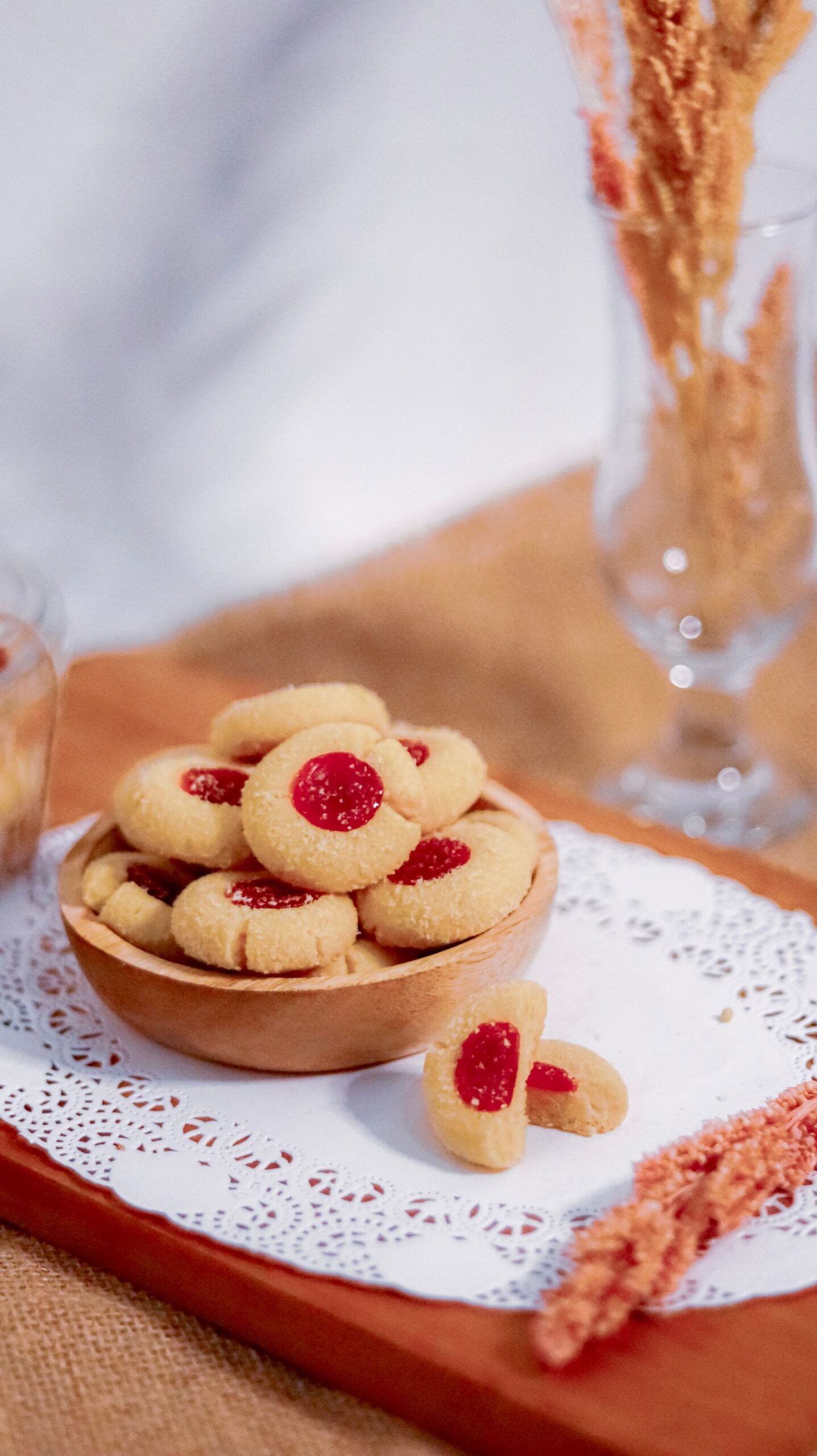 Jam-filled thumbprint cookies in a wooden bowl