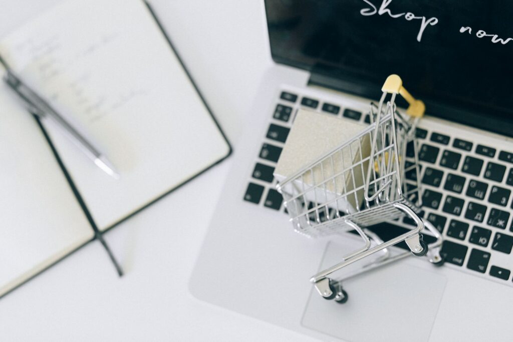 Laptop with a tiny shopping cart for online holiday shopping