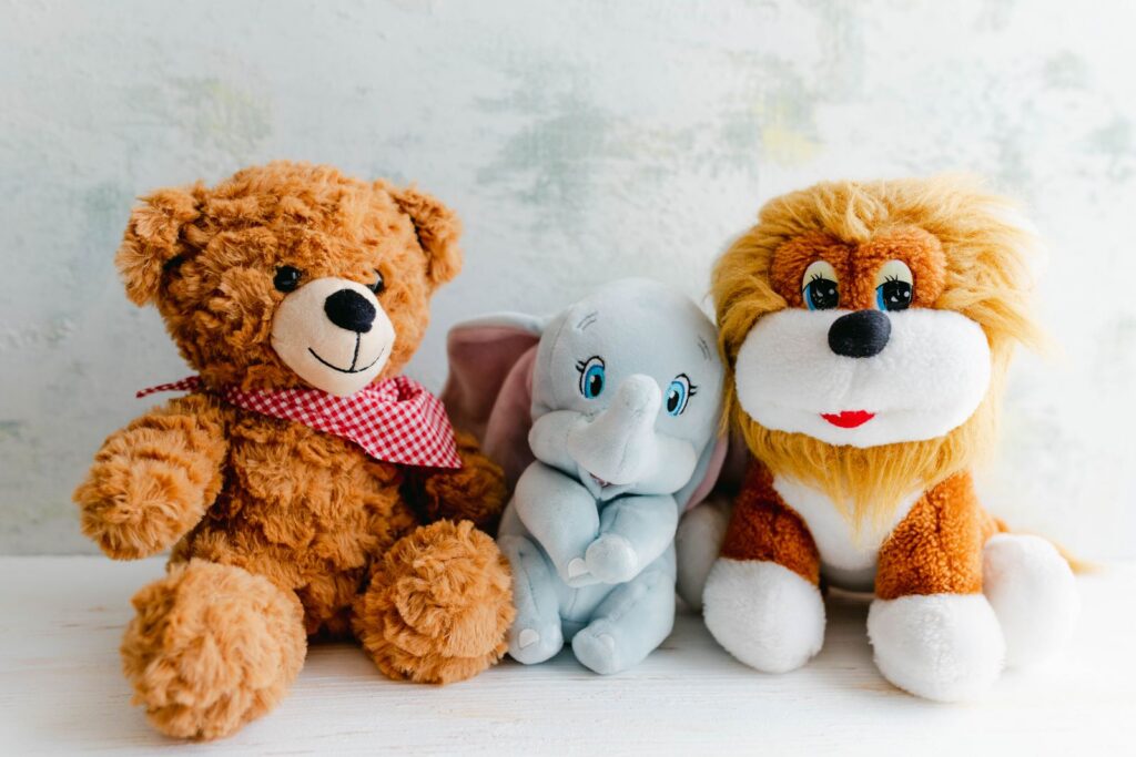 Teddy bear, elephant and lion plush toys lined up
