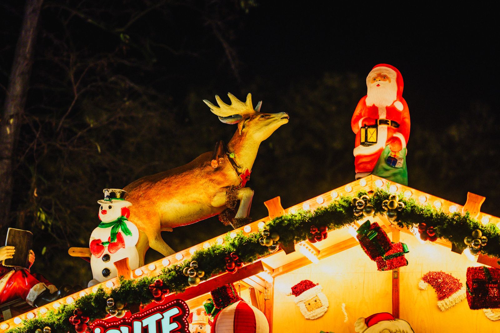 A rooftop Christmas display with a light-up Santa, snowman and reindeer