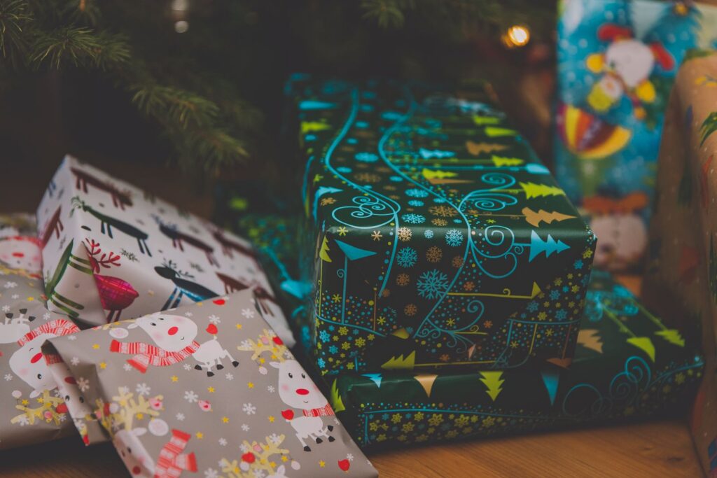 Christmas presents in holiday wrapping paper under the tree