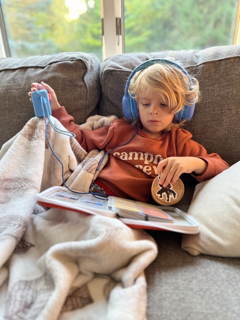 Listening to our Yoto Mini with headphones on the couch
